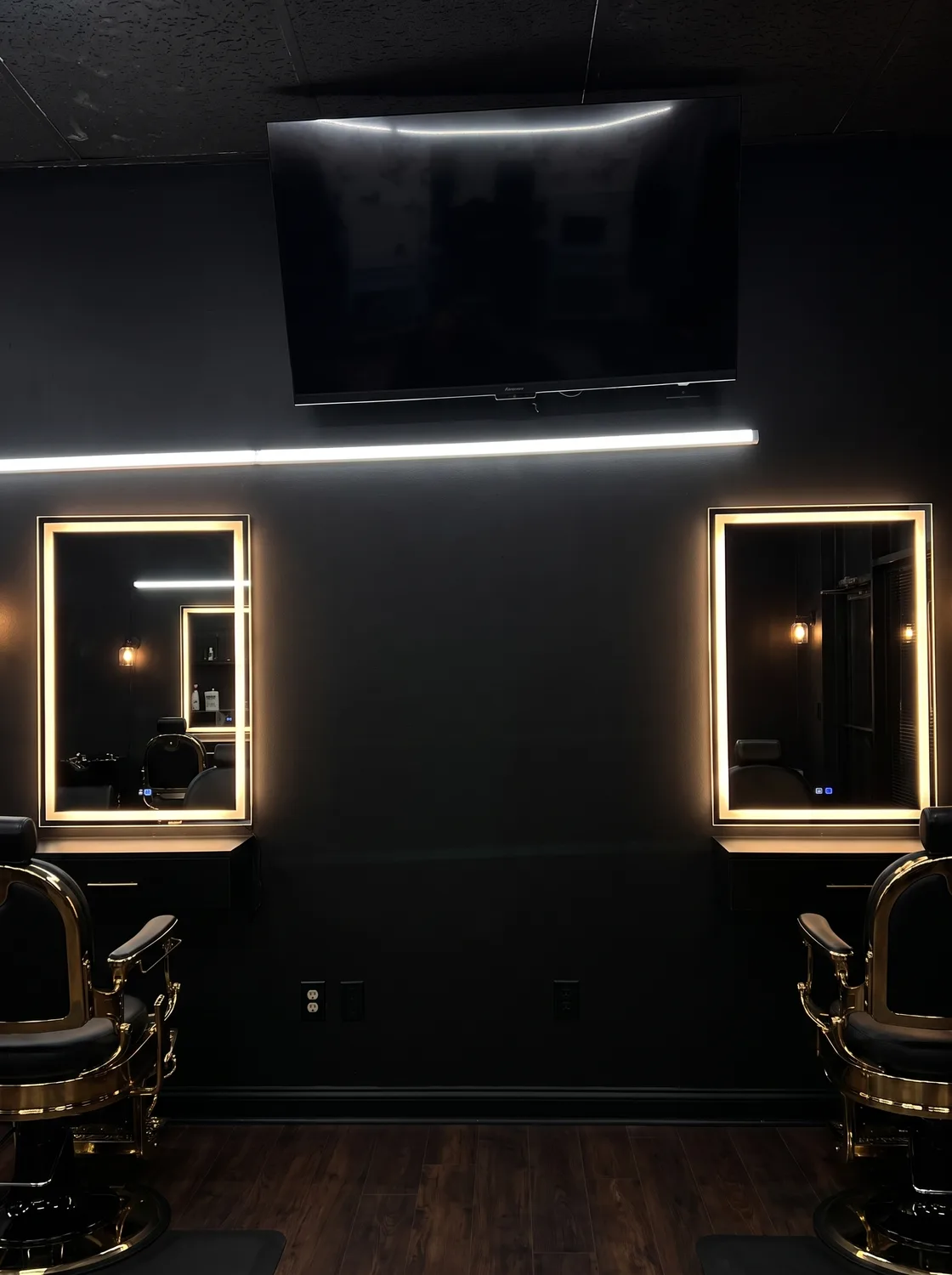 Gold barber chairs and mirror stations